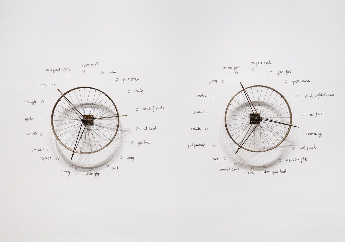 Robert Filliou, Danse-poème aléatoire collectif (à performer deux par deux, chacun(e) tournant une roue)[Collective Dance Poem by Chance  (To Be Performed by Two Players, Each Turning One Wheel)], Reconstruction of a performance from 1962, two metal wheels and charcoal on wall, diameter of each wheel: 64 cm. Courtesy of Estate of Robert Filliou & Peter Freeman, Inc. Photo: Nicholas Knight Studio. © Estate Robert Filliou