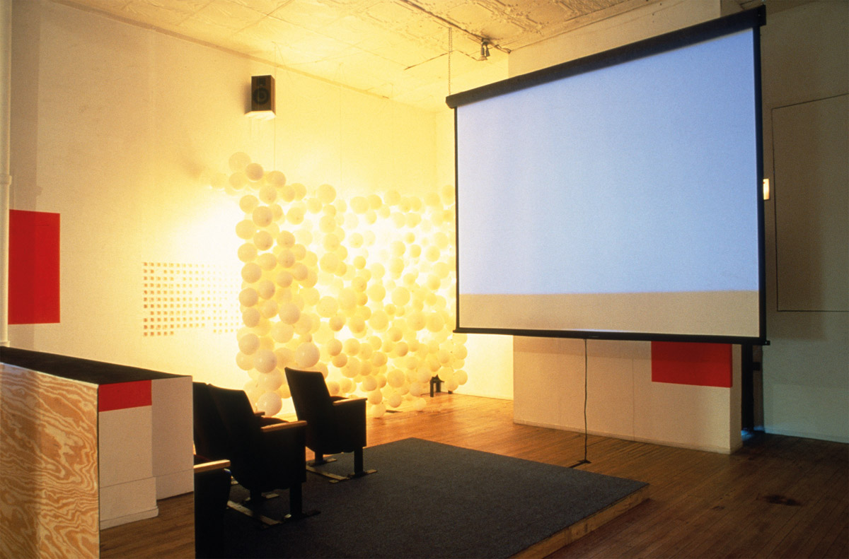 Installation view of disappeared, Randolph Street Gallery, Chicago, featuring Tom Burr’s Approximation of a Chicago Style Blue Movie House (Bijou), 1996, and DerekJarman’s Blue, 1993. Courtesy of John Paul Ricco.