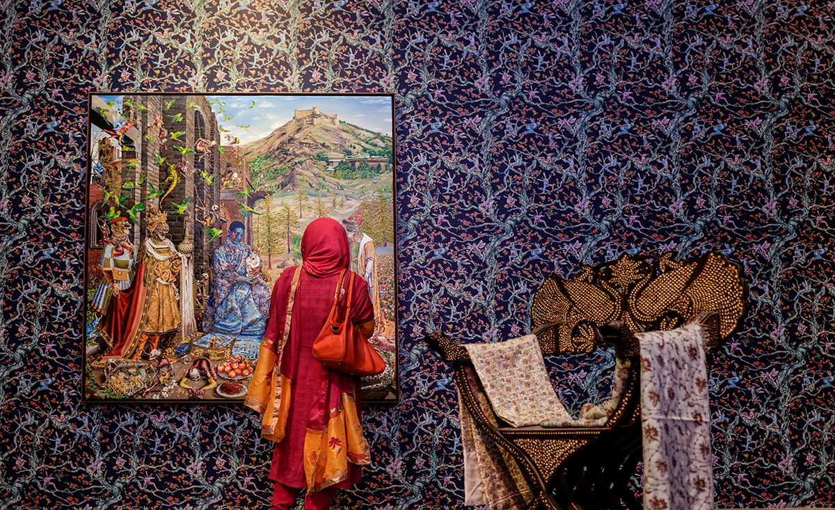 From left: Raqib Shaw, The Adoration (After Jan Gossaert) (2015-2016), courtesy of the artist and White Cube; Chair (used for ceremony-from The Palace of Dinajpur Maharaja, 19th Century, from the collection of the Bangladesh National Museum); and Kashmiri Shawl (from the collection of Raqib Shaw) at the Raqib Shaw exhibition, co-curated by Diana Campbell Betancourt and Dr. Maria Balshaw and the artist. Photographer: Noor Photoface.